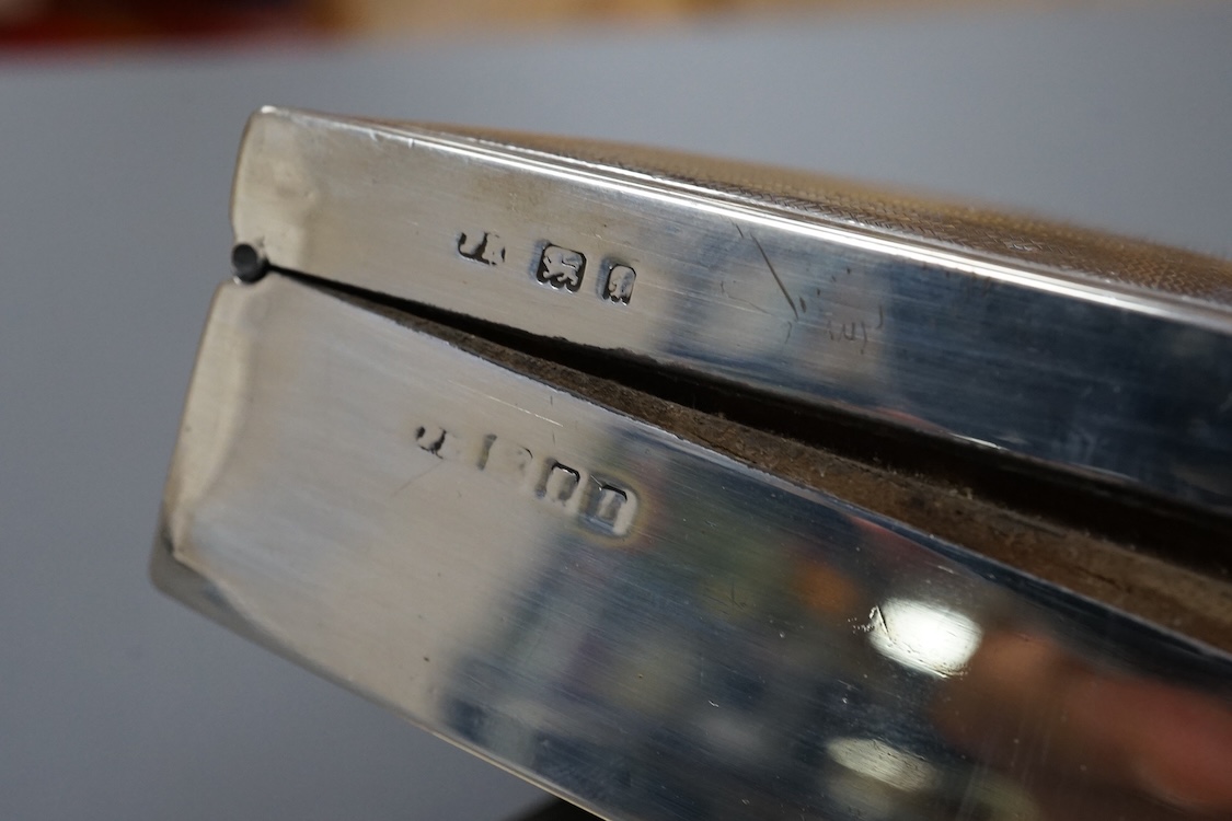 Three assorted silver mounted cigarette boxes, the largest by Frederick William Hentsch, London, 1924, 14.3cm.